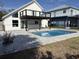 Backyard pool area with stone pavers and deck, perfect for relaxation and summer fun at 4104 Pine Dale Ct, Hernando Beach, FL 34607