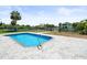 Beautiful backyard pool with landscaping and canal views at 4104 Pine Dale Ct, Hernando Beach, FL 34607