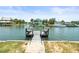 Scenic view of waterfront dock with seating and boat access to canal at 4104 Pine Dale Ct, Hernando Beach, FL 34607