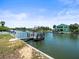 Waterfront view of neighborhood homes along canal with private docks on sunny day, highlighting waterfront living at 4104 Pine Dale Ct, Hernando Beach, FL 34607