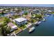 Aerial view showcases a waterfront property with boat dock, lush lawn, and outdoor seating for relaxed waterfront living at 4469 Bahama Dr, Hernando Beach, FL 34607