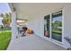 Covered outdoor patio features view of backyard and waterfront, with a table and chairs, kayaks and dive tanks at 4469 Bahama Dr, Hernando Beach, FL 34607
