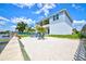 Backyard with a private beach area, lush landscaping, and waterfront access with seating at 4469 Bahama Dr, Hernando Beach, FL 34607