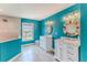 Stylish bathroom features a double vanity, tiled shower, and vibrant blue walls at 4469 Bahama Dr, Hernando Beach, FL 34607