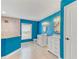 Bright bathroom with blue walls, double vanity, round decorative mirrors, and tiled walk-in shower at 4469 Bahama Dr, Hernando Beach, FL 34607
