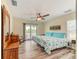 Bedroom with a nautical sign, light wood floors, and sliding door to balcony overlooking the water at 4469 Bahama Dr, Hernando Beach, FL 34607