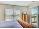 Bedroom with a window and a sliding glass door to the balcony overlooking the outside view at 4469 Bahama Dr, Hernando Beach, FL 34607