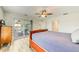 Bright bedroom featuring a ceiling fan, light wood floors, and a sliding door to the outdoor patio at 4469 Bahama Dr, Hernando Beach, FL 34607