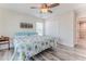 Bedroom with wood-look floors, bright natural light, and coastal-themed decor at 4469 Bahama Dr, Hernando Beach, FL 34607