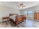 Cozy bedroom featuring a comfortable bed, ceiling fan, and a window with a serene waterfront view at 4469 Bahama Dr, Hernando Beach, FL 34607