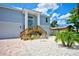 Charming two-story home with a light blue exterior, attached garage, and well-maintained landscaping at 4469 Bahama Dr, Hernando Beach, FL 34607