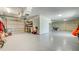 Large garage with durable flooring, a garage door, and a separate storage or work area at 4469 Bahama Dr, Hernando Beach, FL 34607