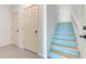 Hallway featuring two doors, stairs with painted risers, and neutral-toned walls at 4469 Bahama Dr, Hernando Beach, FL 34607