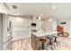 Bright kitchen featuring white cabinetry, a kitchen island with bar seating, and stainless-steel appliances at 4469 Bahama Dr, Hernando Beach, FL 34607