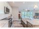 Modern kitchen with stainless steel appliances, a farmhouse sink, and an open layout at 4469 Bahama Dr, Hernando Beach, FL 34607