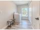 Laundry room with a modern washer and dryer set, bright natural light, and wood-look floors at 4469 Bahama Dr, Hernando Beach, FL 34607
