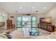 Bright living room featuring waterfront views, a cozy seating area, and entertainment center at 4469 Bahama Dr, Hernando Beach, FL 34607