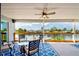Covered patio with comfortable seating, ceiling fan, and scenic waterfront views at 4469 Bahama Dr, Hernando Beach, FL 34607