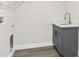 Laundry room with gray cabinet and quartz countertop; includes plumbing for washer and dryer at 4479 Bluewater Ave, Spring Hill, FL 34606