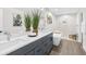 Serene main bathroom with double vanity, modern fixtures, a soaking tub, and a separate walk-in shower at 4479 Bluewater Ave, Spring Hill, FL 34606