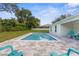 Backyard pool with brick patio and views of lush landscaping providing ultimate outdoor enjoyment at 4479 Bluewater Ave, Spring Hill, FL 34606