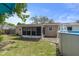 View of the backyard featuring an above ground pool and a screened-in back porch at 4537 Cynthia Ln, Spring Hill, FL 34606