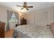 Bedroom features a ceiling fan, hardwood floors, and three large wardrobes at 4537 Cynthia Ln, Spring Hill, FL 34606