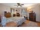 Comfortable bedroom with hardwood floors, ceiling fan, and natural light at 4537 Cynthia Ln, Spring Hill, FL 34606