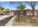 Charming single-story home with a brick facade, mature trees, and a well-maintained front yard and covered carport at 4537 Cynthia Ln, Spring Hill, FL 34606
