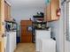 Functional laundry area with cabinets, shelving, and included washer and dryer setup, providing practical laundry solutions at 4537 Cynthia Ln, Spring Hill, FL 34606