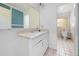 Bathroom featuring white vanity, marble countertop, framed mirror, and a separate toilet room at 507 Jewel St, Brooksville, FL 34601