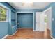 Inviting bedroom featuring wood floors, a built in shelving unit, and a closet for ample storage at 507 Jewel St, Brooksville, FL 34601