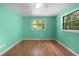 Bedroom with wood flooring, a ceiling fan, and a bright and airy atmosphere at 507 Jewel St, Brooksville, FL 34601