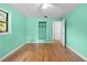Bedroom with wood flooring, a ceiling fan, a closet and a door that provides backyard views at 507 Jewel St, Brooksville, FL 34601