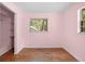 Bedroom featuring wood floors, closet, and window views of the backyard at 507 Jewel St, Brooksville, FL 34601