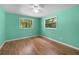 Bright bedroom with wood flooring, a ceiling fan, and large windows at 507 Jewel St, Brooksville, FL 34601