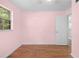 This bedroom has wood floors and a large bright window at 507 Jewel St, Brooksville, FL 34601