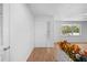 Bright foyer featuring a white front door, hardwood floors, and a decorative brick partition at 507 Jewel St, Brooksville, FL 34601