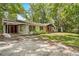 A view of the home's front exterior, which has lots of trees on the property at 507 Jewel St, Brooksville, FL 34601