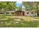 Charming single-story home with brick accents, a red front door, and a well-maintained lawn at 507 Jewel St, Brooksville, FL 34601