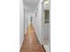 Long hallway with durable wood floors and white trim at 507 Jewel St, Brooksville, FL 34601
