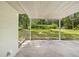 View of the patio, the brick trim, and the green lawn outside at 507 Jewel St, Brooksville, FL 34601