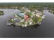 Aerial view of waterfront property with a pool, dock, and lush landscaping on the water at 5440 Manatee Point Drive, New Port Richey, FL 34652