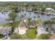 Aerial view of a waterfront home with lush landscaping, a private dock, and a sparkling pool at 5440 Manatee Point Drive, New Port Richey, FL 34652