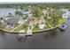 Waterfront property aerial view reveals dock and pool amenities surrounded by lush greenery and scenic waterways at 5440 Manatee Point Drive, New Port Richey, FL 34652
