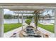 Tranquil backyard oasis with a pond, view of the water, and lush landscaping at 5440 Manatee Point Drive, New Port Richey, FL 34652