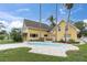 Inviting backyard showcases a kidney-shaped pool, complemented by patio furniture and palm trees at 5440 Manatee Point Drive, New Port Richey, FL 34652