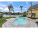 A backyard pool with an interestingly curved perimeter, leading to canal views with private boat docks at 5440 Manatee Point Drive, New Port Richey, FL 34652