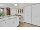 Modern bathroom features marble countertops, a vanity with storage, and closet space at 5440 Manatee Point Drive, New Port Richey, FL 34652