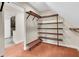 Spacious walk-in closet featuring custom wood shelving and an organized layout at 5440 Manatee Point Drive, New Port Richey, FL 34652